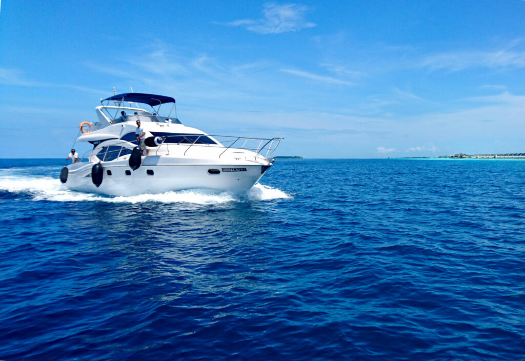 yacht on blue sea with blue skies above